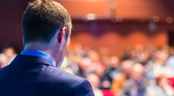 Scaled_bigstock-speaker-at-business-conference-64962394