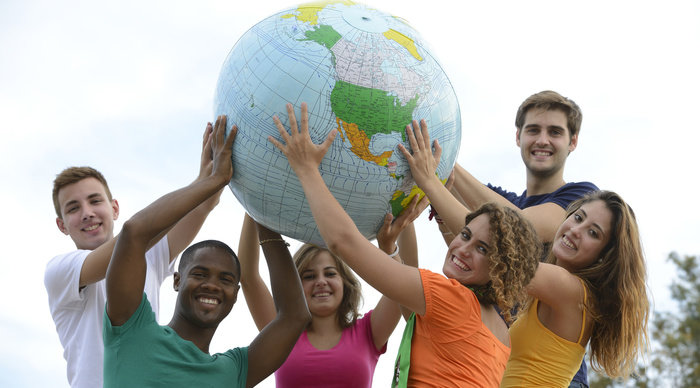 Scaled_teen_holding_globe